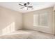 Well-lit bedroom with ceiling fan and carpet flooring at 8630 W Melinda Ln, Peoria, AZ 85382
