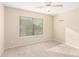 Spacious bedroom with large window and ceiling fan at 8630 W Melinda Ln, Peoria, AZ 85382