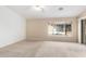 Bright bedroom with carpet flooring and view of the backyard pool at 8630 W Melinda Ln, Peoria, AZ 85382