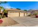 Two-car garage and front yard view of house exterior at 8630 W Melinda Ln, Peoria, AZ 85382