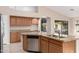 Kitchen features island with sink, granite counters, and stainless steel dishwasher at 8630 W Melinda Ln, Peoria, AZ 85382