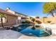 Relaxing kidney-shaped pool surrounded by a patio at 8630 W Melinda Ln, Peoria, AZ 85382