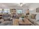 Living room with gray sofas, coffee table, and access to patio at 9444 E Minnesota Ave, Sun Lakes, AZ 85248