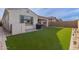 Artificial turf backyard with built-in gas grill and sitting area at 9658 E Tahoe Cir, Mesa, AZ 85212