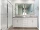 Bathroom with double sink vanity, granite countertops and walk-in glass shower at 9658 E Tahoe Cir, Mesa, AZ 85212