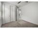 Well-lit bedroom features plush carpet, closet space and easy access to the laundry room at 9658 E Tahoe Cir, Mesa, AZ 85212