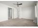 Bright bedroom boasts neutral carpet, white walls, and a modern ceiling fan at 9658 E Tahoe Cir, Mesa, AZ 85212