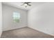 Clean bedroom boasts neutral carpet, white walls, blinds and ceiling fan at 9658 E Tahoe Cir, Mesa, AZ 85212