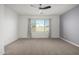 Cozy bedroom features neutral walls and carpet with a large window for natural light at 9658 E Tahoe Cir, Mesa, AZ 85212