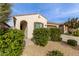 Front view of charming house with lush green bushes at 9658 E Tahoe Cir, Mesa, AZ 85212
