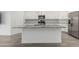 Bright kitchen features stainless appliances, subway tile backsplash, white cabinets, and a large granite countertop island at 9658 E Tahoe Cir, Mesa, AZ 85212