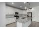 Modern kitchen features stainless appliances, white cabinets, tile backsplash, granite countertops, and pendant lighting above island at 9658 E Tahoe Cir, Mesa, AZ 85212