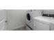 Laundry room features a white washer and dryer with easy access from the bedroom at 9658 E Tahoe Cir, Mesa, AZ 85212