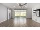Bright, spacious living room with wood-look flooring and sliding glass doors to the backyard at 9658 E Tahoe Cir, Mesa, AZ 85212