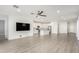 Wide open living room with wood-look floors, recessed lighting, ceiling fan, and modern fixtures at 9658 E Tahoe Cir, Mesa, AZ 85212