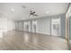Spacious living room with wood-look tile flooring, recessed lighting, modern fixtures, and plenty of natural light at 9658 E Tahoe Cir, Mesa, AZ 85212