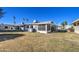 Large backyard with grassy area and screened patio at 9909 W Newport Dr, Sun City, AZ 85351