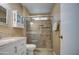 Updated bathroom with granite vanity, glass shower, and built-in storage at 9909 W Newport Dr, Sun City, AZ 85351