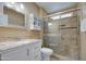 Updated bathroom with granite vanity, glass shower, and built-in storage at 9909 W Newport Dr, Sun City, AZ 85351