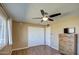 Bedroom with double bed, dresser, and ceiling fan at 9909 W Newport Dr, Sun City, AZ 85351