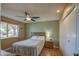 Bright bedroom with double bed, dresser, and large window at 9909 W Newport Dr, Sun City, AZ 85351
