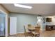 Bright dining area with wood table and chairs, adjacent to kitchen at 9909 W Newport Dr, Sun City, AZ 85351