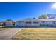 Ranch style home with attached garage and well-manicured lawn at 9909 W Newport Dr, Sun City, AZ 85351