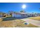 Ranch-style home with attached garage and front yard at 9909 W Newport Dr, Sun City, AZ 85351