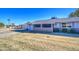 Brick ranch house with a screened patio and yard at 9909 W Newport Dr, Sun City, AZ 85351