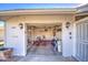 Attached garage with shelving, bicycle, and extra storage at 9909 W Newport Dr, Sun City, AZ 85351