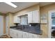 Kitchen with granite countertops and a window overlooking the backyard at 9909 W Newport Dr, Sun City, AZ 85351