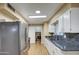 Kitchen boasts granite counters, stainless steel appliances, and wood floors at 9909 W Newport Dr, Sun City, AZ 85351