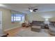 Living room featuring a comfy sectional sofa and ceiling fan at 9909 W Newport Dr, Sun City, AZ 85351