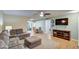 Spacious living room with L-shaped sofa and wood-look flooring at 9909 W Newport Dr, Sun City, AZ 85351