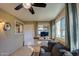 Sunroom with tiled floors, comfy sofa, and lots of natural light at 9909 W Newport Dr, Sun City, AZ 85351