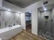 Spa-like bathroom with a soaking tub, walk-in shower, and marble tile at 9992 E Carol Ave, Scottsdale, AZ 85258