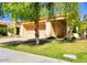 Tan one-story home with terracotta tile roof and a two-car garage at 9992 E Carol Ave, Scottsdale, AZ 85258