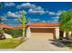 Tan one-story home with terracotta tile roof, cacti, and a two-car garage at 9992 E Carol Ave, Scottsdale, AZ 85258