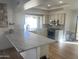 Bright kitchen with breakfast bar, granite countertops, and access to patio at 9992 E Carol Ave, Scottsdale, AZ 85258