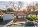 Single-story home with a red tile roof, white exterior, and a detached garage at 1001 N Burk St, Gilbert, AZ 85234