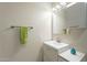 Simple bathroom with updated vanity, mirror, and fresh green towels at 1001 N Burk St, Gilbert, AZ 85234