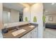 Modern bathroom with a double vanity, grey tile, and plenty of counter space at 1001 N Burk St, Gilbert, AZ 85234