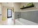 Clean bathroom with a grey tiled tub surround and a modern vanity at 1001 N Burk St, Gilbert, AZ 85234