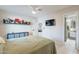 Bright bedroom with ensuite bathroom access, built-in shelves, and a ceiling fan at 1001 N Burk St, Gilbert, AZ 85234