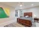 Relaxing bedroom with a wooden bed frame, dresser, and a view of the bathroom at 1001 N Burk St, Gilbert, AZ 85234