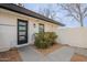 Modern front door with glass panels and landscaping at 1001 N Burk St, Gilbert, AZ 85234