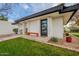 Landscaped front yard with a modern front door and a bench at 1001 N Burk St, Gilbert, AZ 85234