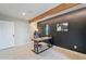 Home office with a large desk, red chair, and a black accent wall at 1001 N Burk St, Gilbert, AZ 85234