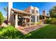 Lovely backyard with patio seating, artificial grass, and built-in grill at 10069 E Turquoise Ave, Scottsdale, AZ 85258