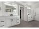 Elegant bathroom with double vanity, marble counters, and large mirror at 10069 E Turquoise Ave, Scottsdale, AZ 85258